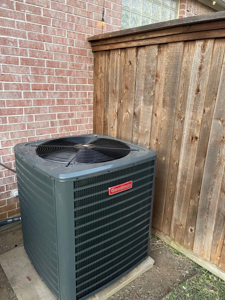 New central air conditioning installation in Dallas, TX, Technician repairing HVAC system, Brands we service - General Electric, Viking, Kenmore.