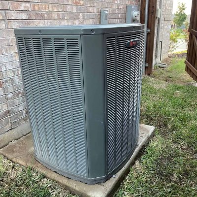 HVAC outdoor unit installed beside a brick wall, ensuring efficient climate control for your home.